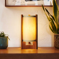 Teak Table Lamp with Sand Lampshade illuminated on dresser next to art and plants