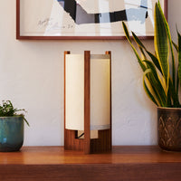 Teak Table Lamp with Sand Lampshade on dresser next to art and plants