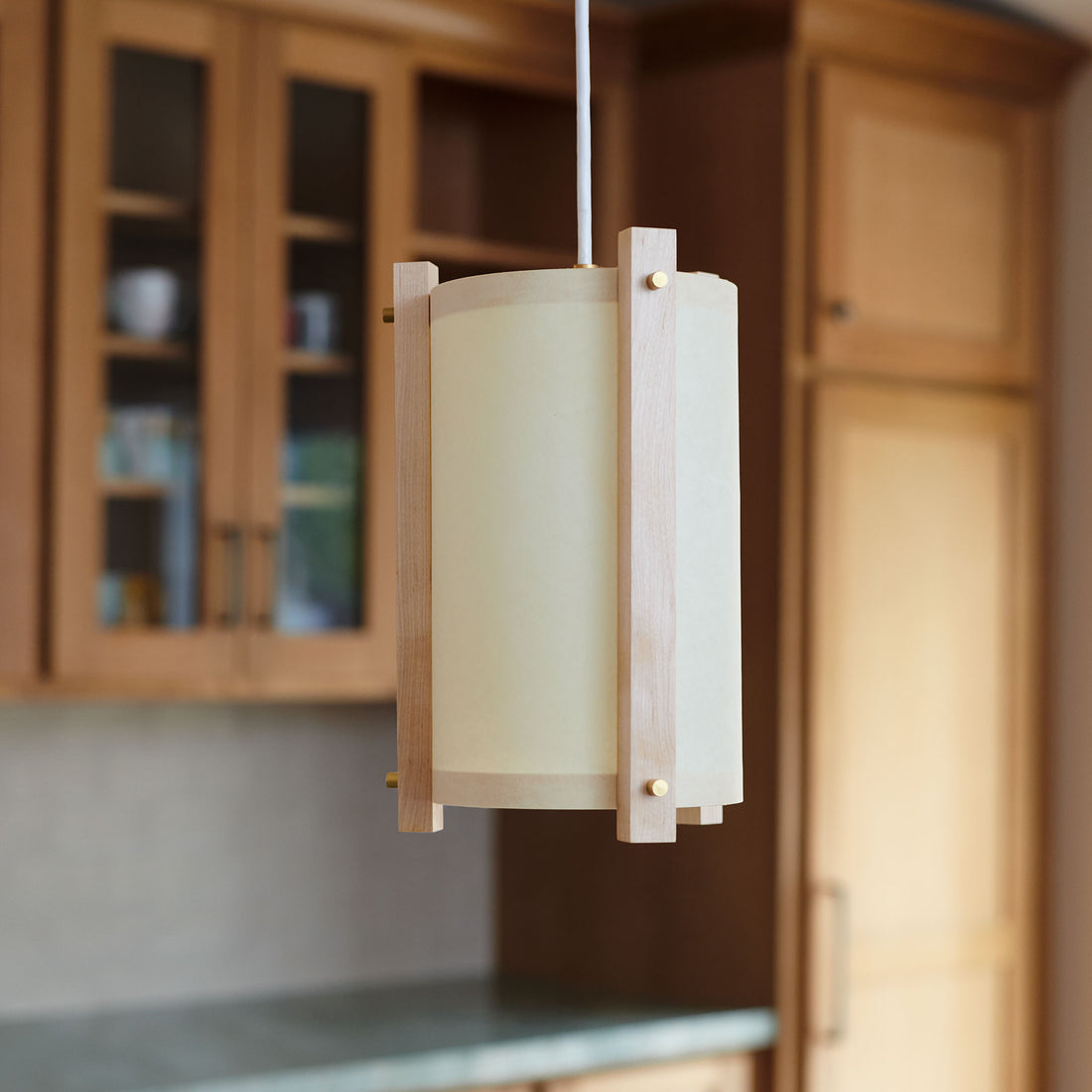 Maple and white pendant in kitchen