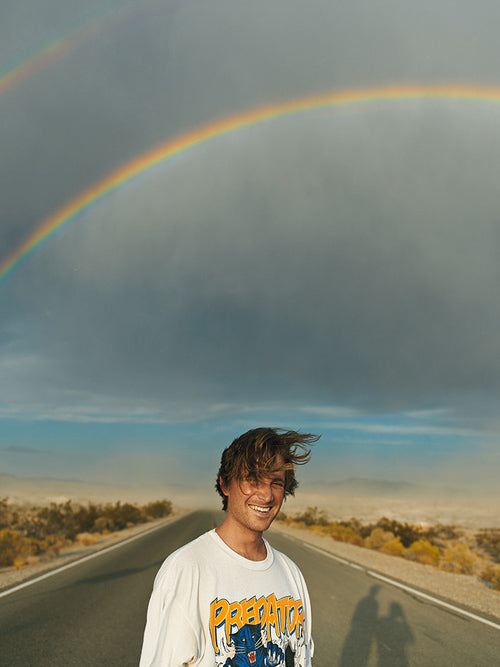 Man in road with rainbows