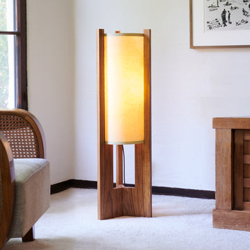 Teak Floor Lamp illuminated in corner with chair window and dresser