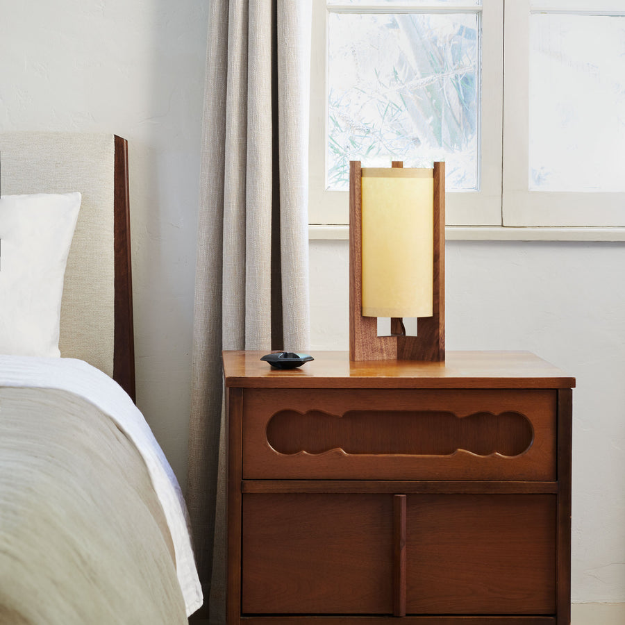 Walnut Table Lamp with Sand Lampshade on nightstand next to bed and window