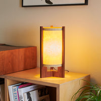 Japanese Mid Century Walnut Table Lamp next to a stereo