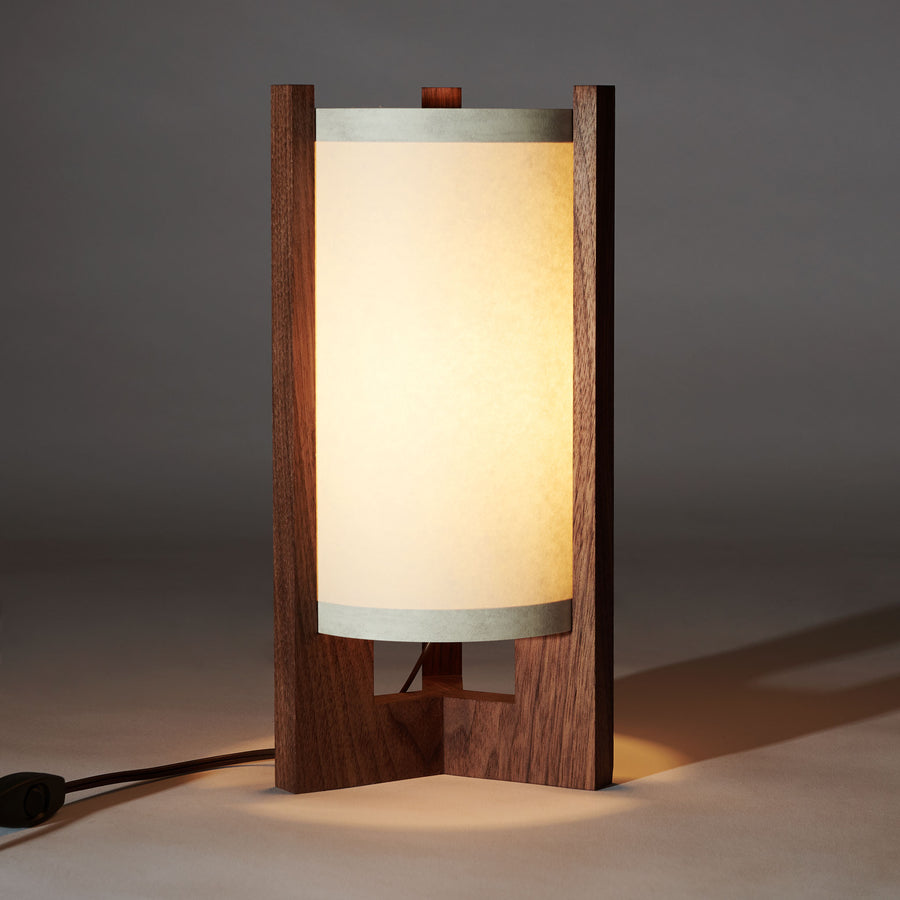 Japanese Mid Century Walnut Table Lamp illuminated with white lampshade